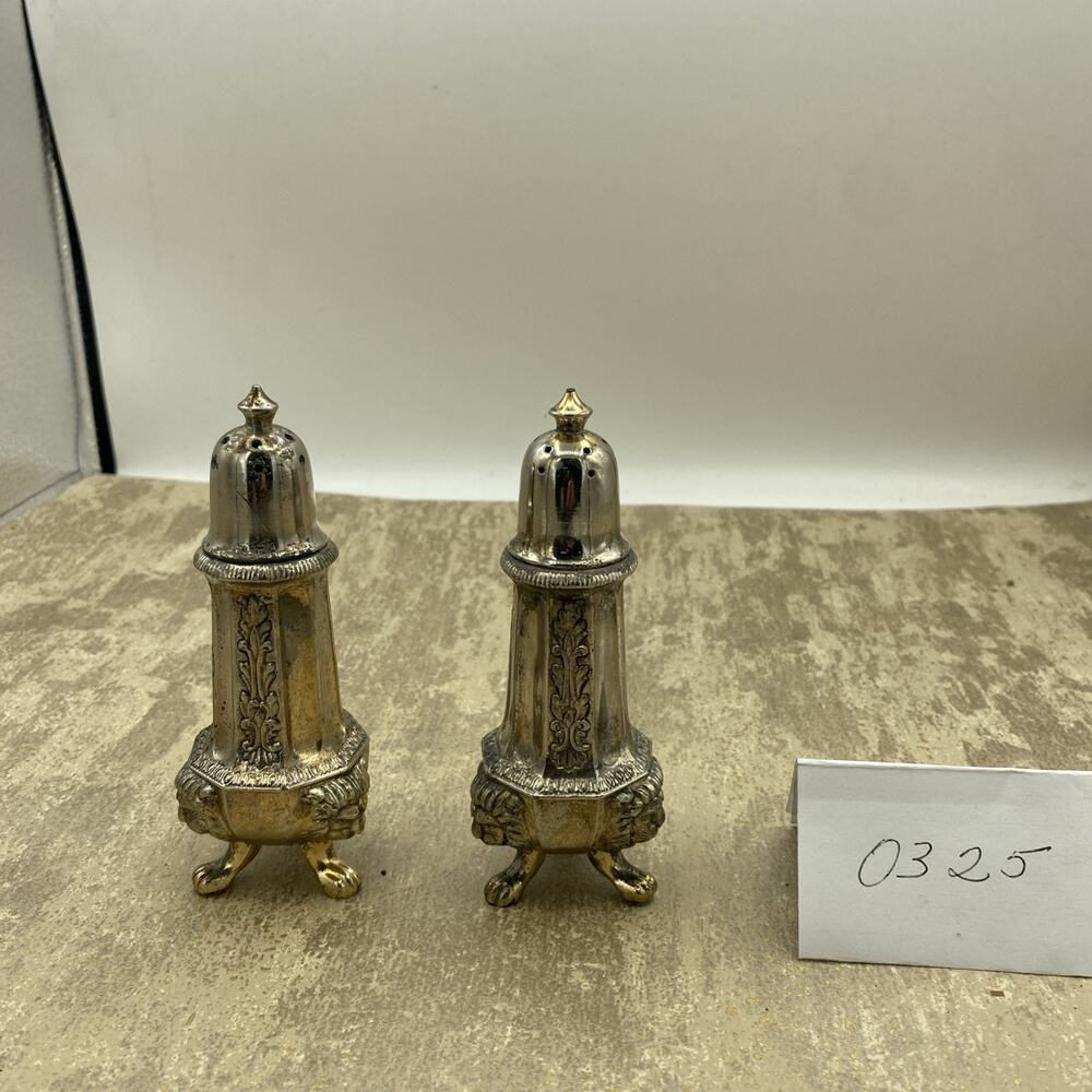 Silver plated salt and pepper shaker has lion heads on the bottom HEAVY 5” Tall